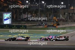 Pietro Fittipaldi (BRA) Haas VF-19 leads Sergio Perez (MEX) Racing Point F1 Team RP19 and Kimi Raikkonen (FIN) Alfa Romeo Racing C39. 06.12.2020. Formula 1 World Championship, Rd 16, Sakhir Grand Prix, Sakhir, Bahrain, Race Day.