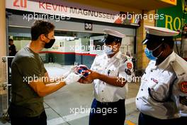 Romain Grosjean (FRA) Haas F1 Team with marshals who assisted in his escape from the fiery crash at the Bahrain Grand Prix. 03.12.2020. Formula 1 World Championship, Rd 16, Sakhir Grand Prix, Sakhir, Bahrain, Preparation Day.