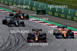 Max Verstappen (NLD) Red Bull Racing RB16 and Carlos Sainz Jr (ESP) McLaren MCL35 battle for position at the start of the race. 12.07.2020. Formula 1 World Championship, Rd 2, Steiermark Grand Prix, Spielberg, Austria, Race Day.