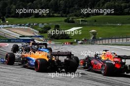 Carlos Sainz Jr (ESP) McLaren MCL35 and Max Verstappen (NLD) Red Bull Racing RB16 at the start of the race. 12.07.2020. Formula 1 World Championship, Rd 2, Steiermark Grand Prix, Spielberg, Austria, Race Day.