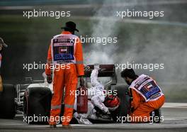 Kimi Raikkonen (FIN) Alfa Romeo Racing C39 in the second practice session with marshals putting out a fire. 11.12.2020. Formula 1 World Championship, Rd 17, Abu Dhabi Grand Prix, Yas Marina Circuit, Abu Dhabi, Practice Day.