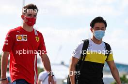 Charles Leclerc (MON) Ferrari with Guanyu Zhou (CHN) Renault F1 Team Test Driver. 11.12.2020. Formula 1 World Championship, Rd 17, Abu Dhabi Grand Prix, Yas Marina Circuit, Abu Dhabi, Practice Day.