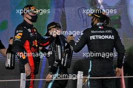 (L to R): Race winner Max Verstappen (NLD) Red Bull Racing celebrates on the podium with third placed Lewis Hamilton (GBR) Mercedes AMG F1. 13.12.2020. Formula 1 World Championship, Rd 17, Abu Dhabi Grand Prix, Yas Marina Circuit, Abu Dhabi, Race Day.