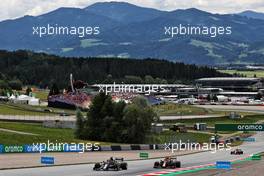 Yuki Tsunoda (JPN) AlphaTauri AT02 and Max Verstappen (NLD) Red Bull Racing RB16B. 02.07.2021. Formula 1 World Championship, Rd 9, Austrian Grand Prix, Spielberg, Austria, Practice Day.