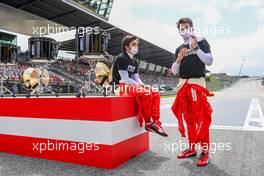 (L to R): Carlos Sainz Jr (ESP) Ferrari and Charles Leclerc (MON) Ferrari on the grid. 04.07.2021. Formula 1 World Championship, Rd 9, Austrian Grand Prix, Spielberg, Austria, Race Day.