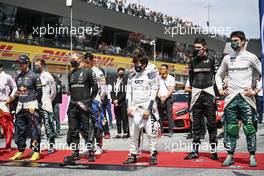 Yuki Tsunoda (JPN) AlphaTauri as the grid observes the national anthem. 04.07.2021. Formula 1 World Championship, Rd 9, Austrian Grand Prix, Spielberg, Austria, Race Day.