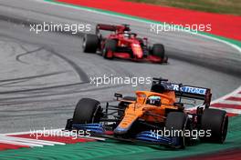Daniel Ricciardo (AUS) McLaren MCL35M leads Charles Leclerc (MON) Ferrari. 04.07.2021. Formula 1 World Championship, Rd 9, Austrian Grand Prix, Spielberg, Austria, Race Day.