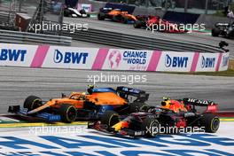 Lando Norris (GBR) McLaren MCL35M and Sergio Perez (MEX) Red Bull Racing RB16B battle for position. 04.07.2021. Formula 1 World Championship, Rd 9, Austrian Grand Prix, Spielberg, Austria, Race Day.