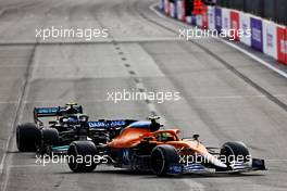 Lando Norris (GBR) McLaren MCL35M and Valtteri Bottas (FIN) Mercedes AMG F1 W12 battle for position. 06.06.2021. Formula 1 World Championship, Rd 6, Azerbaijan Grand Prix, Baku Street Circuit, Azerbaijan, Race Day.