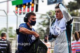 George Russell (GBR) Williams Racing with Aleix Casanovas, Williams Racing Personal Trainer in the pits while the race is stopped. 06.06.2021. Formula 1 World Championship, Rd 6, Azerbaijan Grand Prix, Baku Street Circuit, Azerbaijan, Race Day.