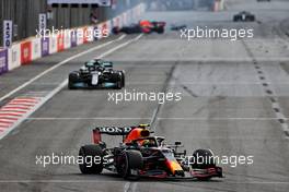 Sergio Perez (MEX) Red Bull Racing RB16B with his team mate Max Verstappen (NLD) Red Bull Racing RB16B crashed out in the background. 06.06.2021. Formula 1 World Championship, Rd 6, Azerbaijan Grand Prix, Baku Street Circuit, Azerbaijan, Race Day.
