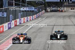 Lando Norris (GBR) McLaren MCL35M and Valtteri Bottas (FIN) Mercedes AMG F1 W12 battle for position. 06.06.2021. Formula 1 World Championship, Rd 6, Azerbaijan Grand Prix, Baku Street Circuit, Azerbaijan, Race Day.