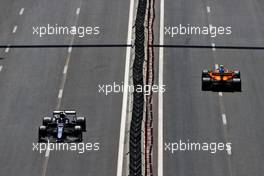 Yuki Tsunoda (JPN) AlphaTauri AT02 and Lando Norris (GBR) McLaren MCL35M. 05.06.2021. Formula 1 World Championship, Rd 6, Azerbaijan Grand Prix, Baku Street Circuit, Azerbaijan, Qualifying Day.
