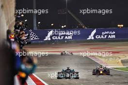 Race winner Lewis Hamilton (GBR) Mercedes AMG F1 W12 takes the chequered flag at the end of the race ahead of second placed Max Verstappen (NLD) Red Bull Racing RB16B. 28.03.2021. Formula 1 World Championship, Rd 1, Bahrain Grand Prix, Sakhir, Bahrain, Race Day.