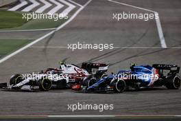Antonio Giovinazzi (ITA) Alfa Romeo Racing C41 and Esteban Ocon (FRA) Alpine F1 Team A521 battle for position. 28.03.2021. Formula 1 World Championship, Rd 1, Bahrain Grand Prix, Sakhir, Bahrain, Race Day.