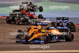 Lando Norris (GBR) McLaren MCL35M and Daniel Ricciardo (AUS) McLaren MCL35M battle for position. 28.03.2021. Formula 1 World Championship, Rd 1, Bahrain Grand Prix, Sakhir, Bahrain, Race Day.