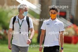 Lando Norris (GBR) McLaren with Mark Berryman (GBR) Add Motorsports Director and Driver Manager. 27.03.2021. Formula 1 World Championship, Rd 1, Bahrain Grand Prix, Sakhir, Bahrain, Qualifying Day.