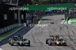 (L to R): Lewis Hamilton (GBR) Mercedes AMG F1 W12 and Sergio Perez (MEX) Red Bull Racing RB16B battle for position. 14.11.2021. Formula 1 World Championship, Rd 19, Brazilian Grand Prix, Sao Paulo, Brazil, Race Day.