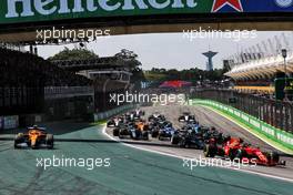 Lando Norris (GBR) McLaren MCL35M runs wide with a puncture after contact with Carlos Sainz Jr (ESP) Ferrari SF-21 (Right) at the start of the race. 14.11.2021. Formula 1 World Championship, Rd 19, Brazilian Grand Prix, Sao Paulo, Brazil, Race Day.