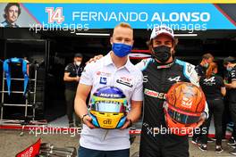 (L to R): Nikita Mazepin (RUS) Haas F1 Team and Fernando Alonso (ESP) Alpine F1 Team - helmet swap. 17.06.2021. Formula 1 World Championship, Rd 7, French Grand Prix, Paul Ricard, France, Preparation Day.