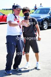 Yuki Tsunoda (JPN) AlphaTauri with a fan. 16.07.2021. Formula 1 World Championship, Rd 10, British Grand Prix, Silverstone, England, Practice Day.