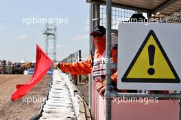 Circuit atmosphere - marshal waves a red flag. 16.07.2021. Formula 1 World Championship, Rd 10, British Grand Prix, Silverstone, England, Practice Day.