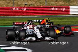 Kimi Raikkonen (FIN) Alfa Romeo Racing C41 and Sergio Perez (MEX) Red Bull Racing RB16B battle for position. 18.07.2021. Formula 1 World Championship, Rd 10, British Grand Prix, Silverstone, England, Race Day.