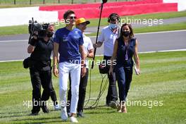 George Russell (GBR) Williams Racing and Lando Norris (GBR) McLaren with Natalie Pinkham (GBR) Sky Sports Presenter on the drivers parade. 18.07.2021. Formula 1 World Championship, Rd 10, British Grand Prix, Silverstone, England, Race Day.
