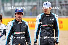 (L to R): Fernando Alonso (ESP) Alpine F1 Team and team mate Esteban Ocon (FRA) Alpine F1 Team - 2022 Car Launch. 15.07.2021. Formula 1 World Championship, Rd 10, British Grand Prix, Silverstone, England, Preparation Day.
