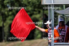 Marshal waves a red flag in the first practice session. 30.07.2021. Formula 1 World Championship, Rd 11, Hungarian Grand Prix, Budapest, Hungary, Practice Day.