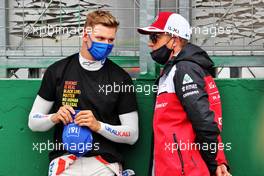 (L to R): Mick Schumacher (GER) Haas F1 Team with Kimi Raikkonen (FIN) Alfa Romeo Racing on the grid. 01.08.2021. Formula 1 World Championship, Rd 11, Hungarian Grand Prix, Budapest, Hungary, Race Day.