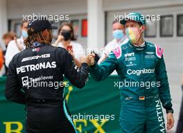 Lewis Hamilton (GBR) Mercedes AMG F1 celebrates his third position with second placed Sebastian Vettel (GER) Aston Martin F1 Team in parc ferme. 01.08.2021. Formula 1 World Championship, Rd 11, Hungarian Grand Prix, Budapest, Hungary, Race Day.