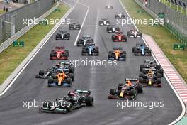 Lewis Hamilton (GBR) Mercedes AMG F1 W12 leads at the start of the race as Valtteri Bottas (FIN) Mercedes AMG F1 W12 crashes into the back of Lando Norris (GBR) McLaren MCL35M. 01.08.2021. Formula 1 World Championship, Rd 11, Hungarian Grand Prix, Budapest, Hungary, Race Day.