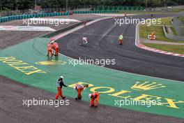 Marshals clean the circuit after the race is stopped. 01.08.2021. Formula 1 World Championship, Rd 11, Hungarian Grand Prix, Budapest, Hungary, Race Day.
