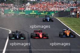 Carlos Sainz Jr (ESP) Ferrari SF-21 and Lewis Hamilton (GBR) Mercedes AMG F1 W12 battle for position. 01.08.2021. Formula 1 World Championship, Rd 11, Hungarian Grand Prix, Budapest, Hungary, Race Day.