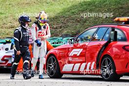 Mick Schumacher (GER) Haas VF-21 with Dr Ian Roberts (GBR) FIA Doctor after he crashed in the second practice session. 31.07.2021. Formula 1 World Championship, Rd 11, Hungarian Grand Prix, Budapest, Hungary, Qualifying Day.