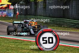 Lewis Hamilton (GBR) Mercedes AMG F1 W12 passes Lando Norris (GBR) McLaren MCL35M for second position. 18.04.2021. Formula 1 World Championship, Rd 2, Emilia Romagna Grand Prix, Imola, Italy, Race Day.