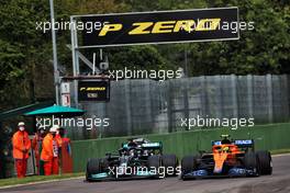 (L to R): Lewis Hamilton (GBR) Mercedes AMG F1 W12 and Lando Norris (GBR) McLaren MCL35M battle for position. 18.04.2021. Formula 1 World Championship, Rd 2, Emilia Romagna Grand Prix, Imola, Italy, Race Day.