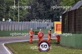 Marshals clean away the debris while the race is stopped. 18.04.2021. Formula 1 World Championship, Rd 2, Emilia Romagna Grand Prix, Imola, Italy, Race Day.