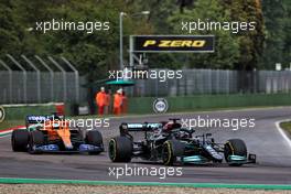 Lewis Hamilton (GBR) Mercedes AMG F1 W12 passes Daniel Ricciardo (AUS) McLaren MCL35M. 18.04.2021. Formula 1 World Championship, Rd 2, Emilia Romagna Grand Prix, Imola, Italy, Race Day.