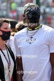 Usain Bolt (JAM) Athlete with Ellie Norman, F1 Director of Marketing and Communications on the grid. 12.09.2021. Formula 1 World Championship, Rd 14, Italian Grand Prix, Monza, Italy, Race Day.