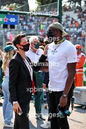 Usain Bolt (JAM) Athlete with Ellie Norman, F1 Director of Marketing and Communications on the grid. 12.09.2021. Formula 1 World Championship, Rd 14, Italian Grand Prix, Monza, Italy, Race Day.