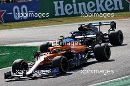 Lando Norris (GBR) McLaren MCL35M leads Lewis Hamilton (GBR) Mercedes AMG F1 W12. 12.09.2021. Formula 1 World Championship, Rd 14, Italian Grand Prix, Monza, Italy, Race Day.