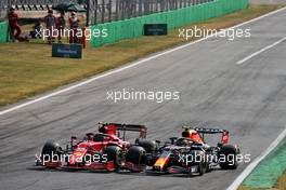 (L to R): Carlos Sainz Jr (ESP) Ferrari SF-21 and Sergio Perez (MEX) Red Bull Racing RB16B battle for position. 12.09.2021. Formula 1 World Championship, Rd 14, Italian Grand Prix, Monza, Italy, Race Day.