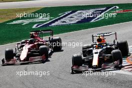 Carlos Sainz Jr (ESP) Ferrari SF-21 and Sergio Perez (MEX) Red Bull Racing RB16B battle for position. 12.09.2021. Formula 1 World Championship, Rd 14, Italian Grand Prix, Monza, Italy, Race Day.