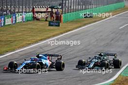 (L to R): Esteban Ocon (FRA) Alpine F1 Team A521 and Sebastian Vettel (GER) Aston Martin F1 Team AMR21 battle for position. 12.09.2021. Formula 1 World Championship, Rd 14, Italian Grand Prix, Monza, Italy, Race Day.