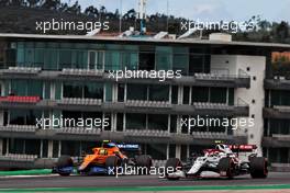 (L to R): Lando Norris (GBR) McLaren MCL35M and Antonio Giovinazzi (ITA) Alfa Romeo Racing C41. 01.05.2021. Formula 1 World Championship, Rd 3, Portuguese Grand Prix, Portimao, Portugal, Qualifying Day.