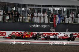 Charles Leclerc (MON) Ferrari SF-21 and Kimi Raikkonen (FIN) Alfa Romeo Racing C41 battle for position. 21.11.2021. Formula 1 World Championship, Rd 20, Qatar Grand Prix, Doha, Qatar, Race Day.