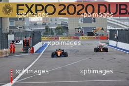 Lando Norris (GBR) McLaren MCL35M heads into the pits as Max Verstappen (NLD) Red Bull Racing RB16B passes him. 26.09.2021. Formula 1 World Championship, Rd 15, Russian Grand Prix, Sochi Autodrom, Sochi, Russia, Race Day.