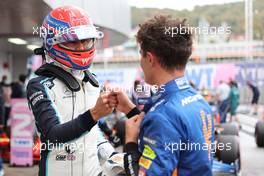 George Russell (GBR) Williams Racing FW43B and Lando Norris (GBR) McLaren MCL35M. 25.09.2021. Formula 1 World Championship, Rd 15, Russian Grand Prix, Sochi Autodrom, Sochi, Russia, Qualifying Day.